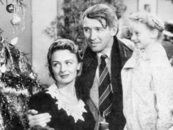 Jimmy Stewart and Donna Reed, with young Karolyn Grimes.