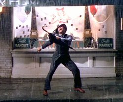 Gene Kelly tap dancing and singing the title song Singin' in the Rain