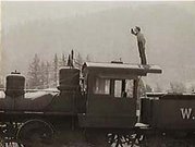 Buster Keaton did his own stunts for the movie.  Here he stands atop the cab of a moving locomotive trying to see farther ahead down the track.